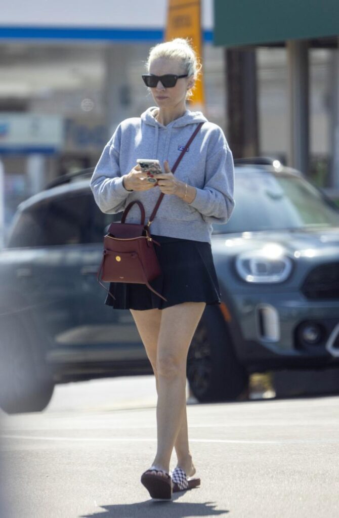 Photo of Jordyn Blum leaving a tennis match. She is walking with her phone in hand.